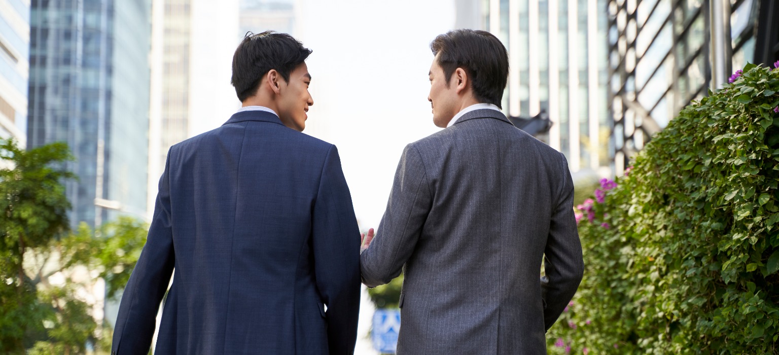 asian business executives walking downtown