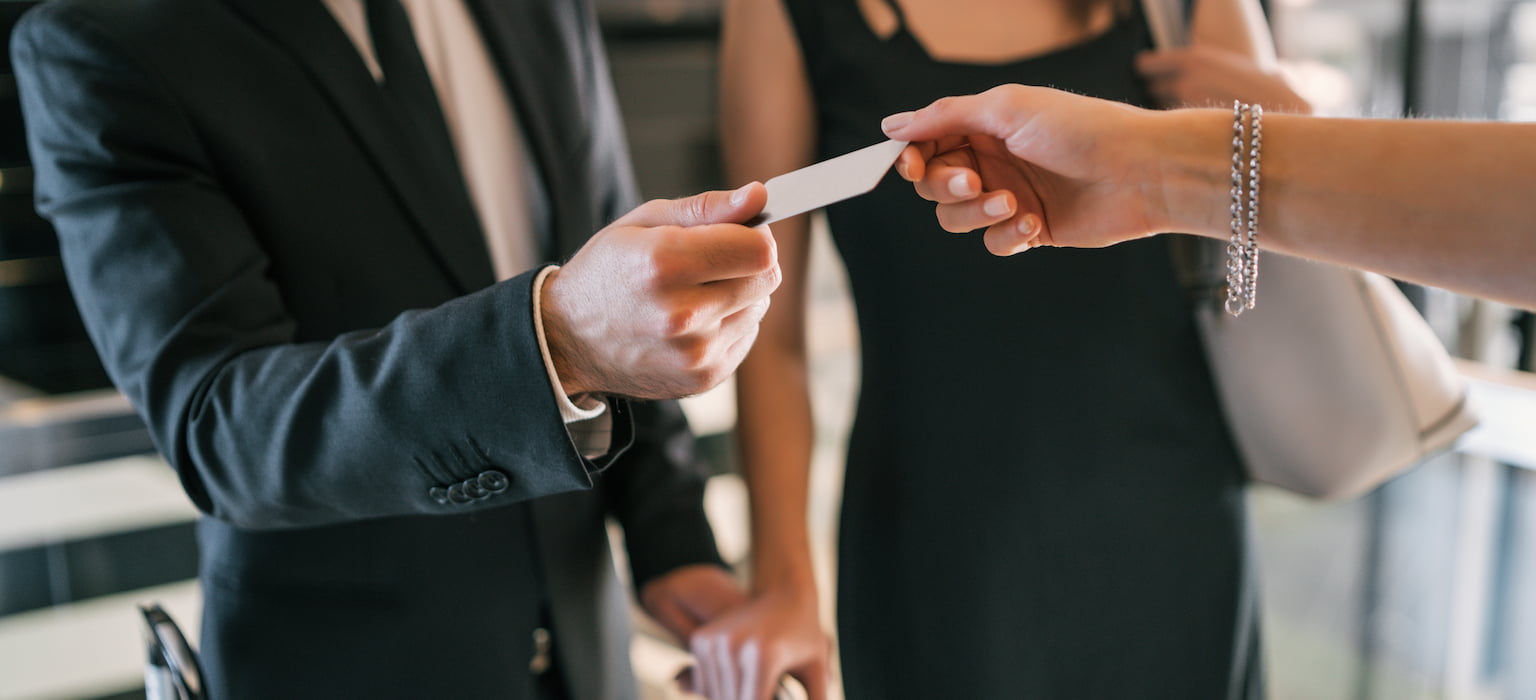 business people makes card payment at check-in at reception