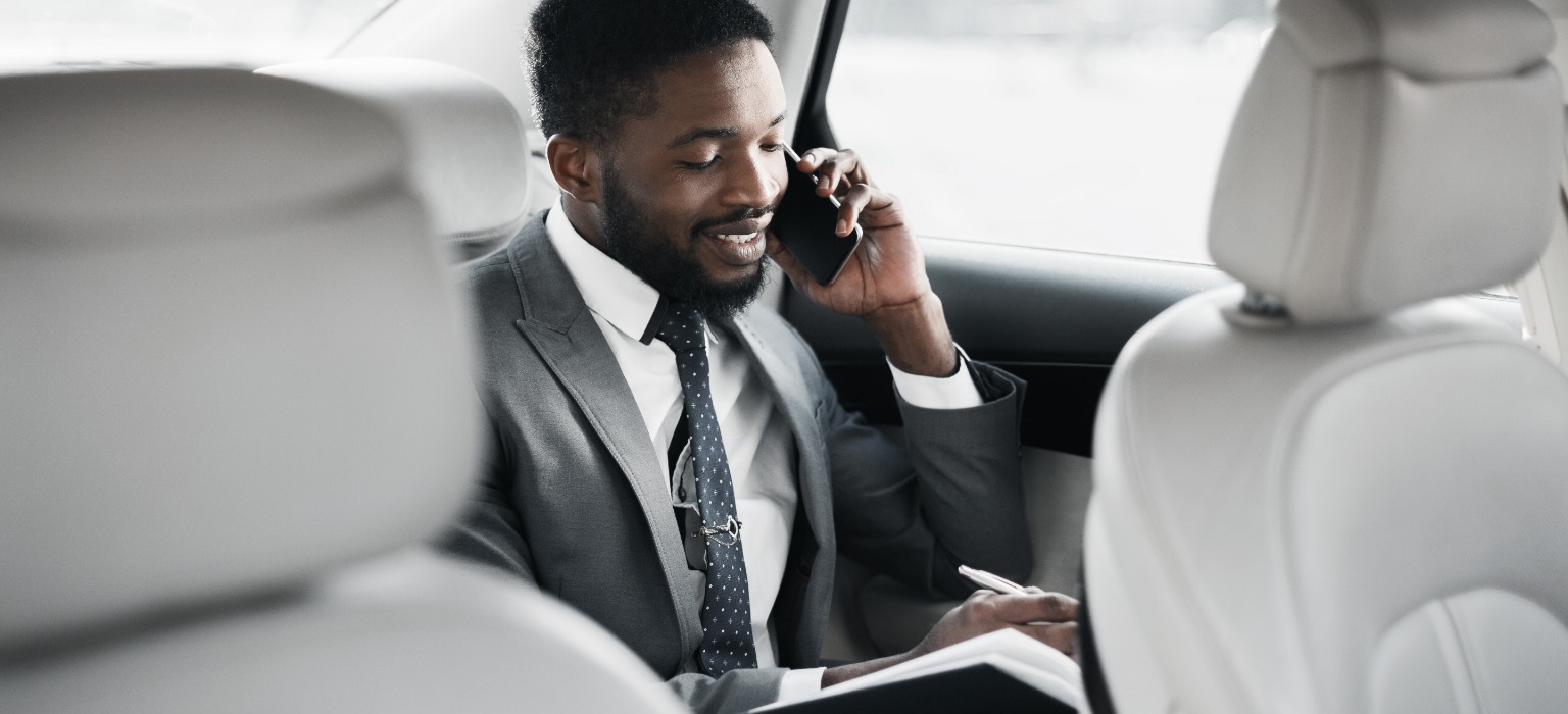 businessman planning day talking phone car