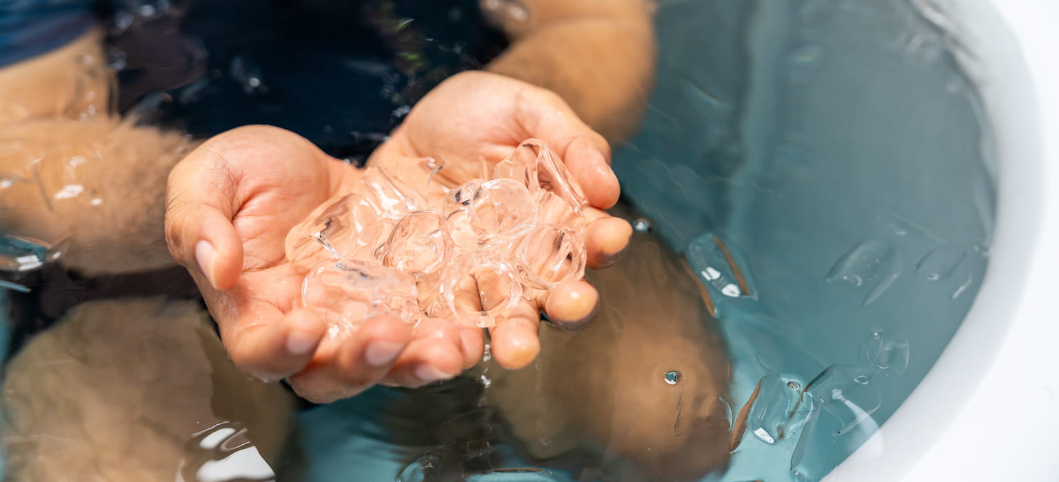 man practices cold therapy ice bathing