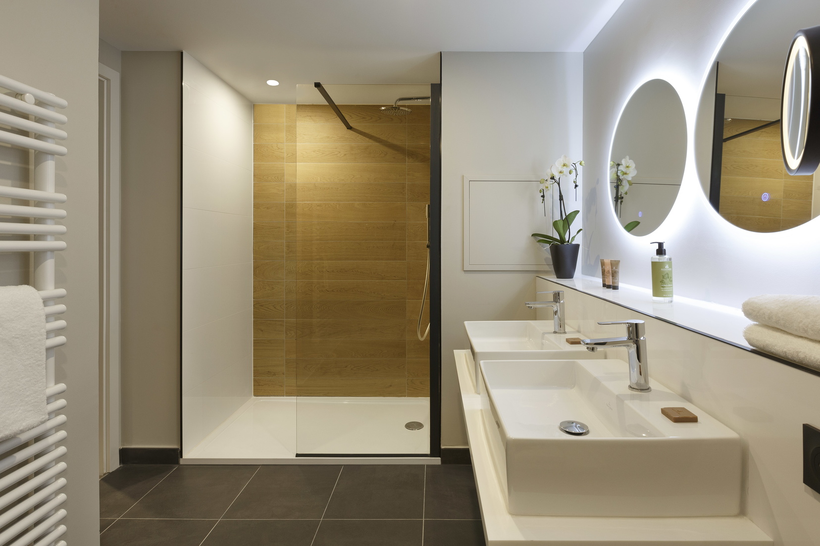 Salle de bain d'un Appartement 2 pièces équipée d'une douche, d'articles de toilette et serviettes, appart hotel Strasbourg